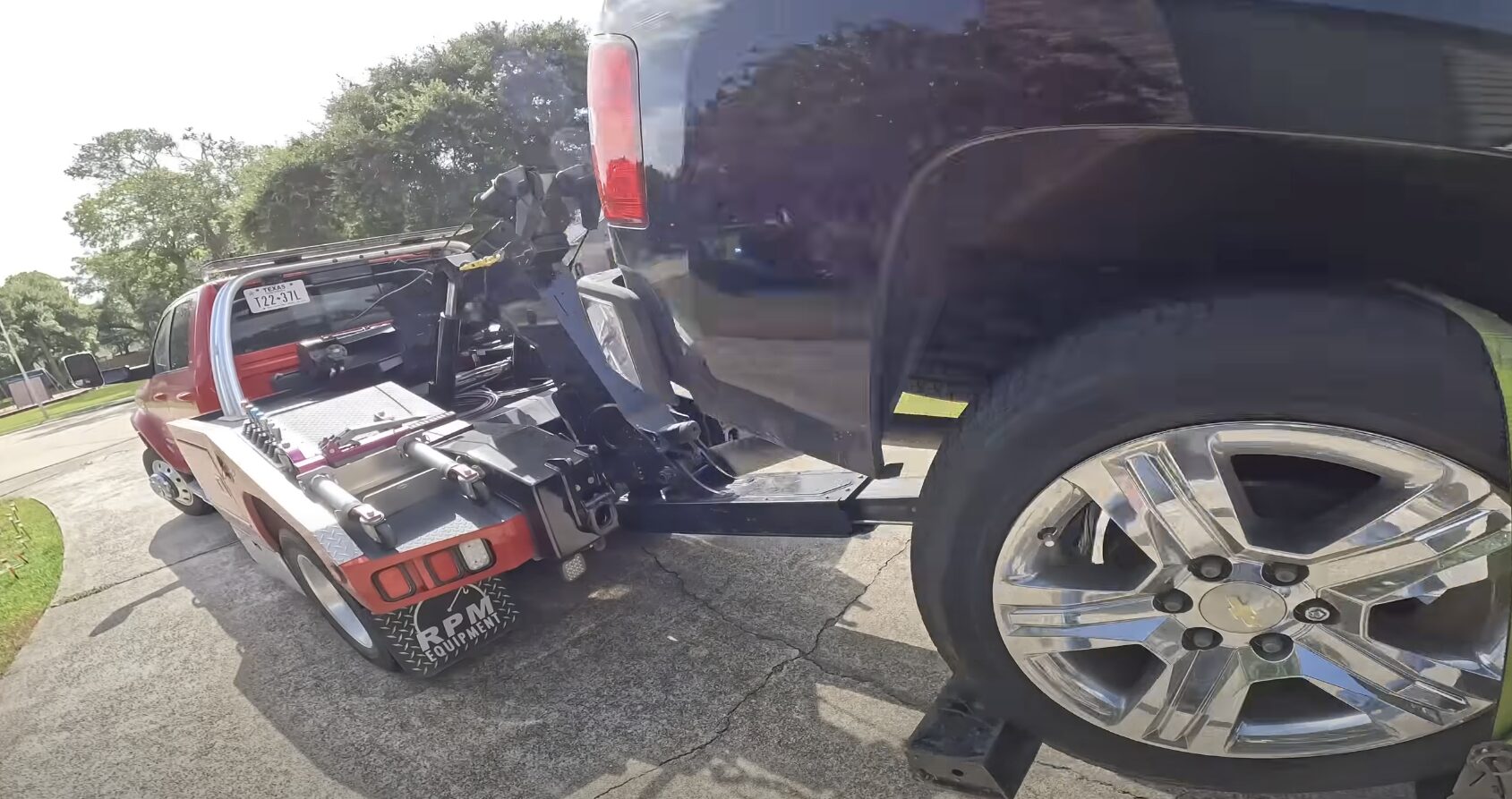 Professional Vehicle Protection During Towing Professional tow truck operator securing a damaged vehicle